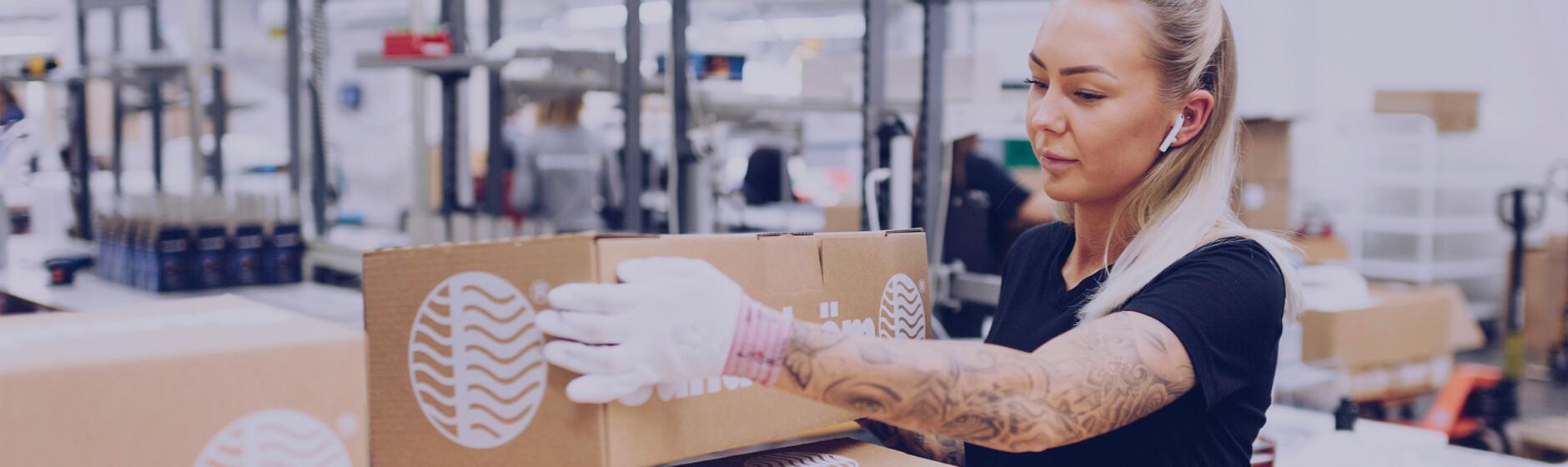 Woman with Tattoos working in the factory